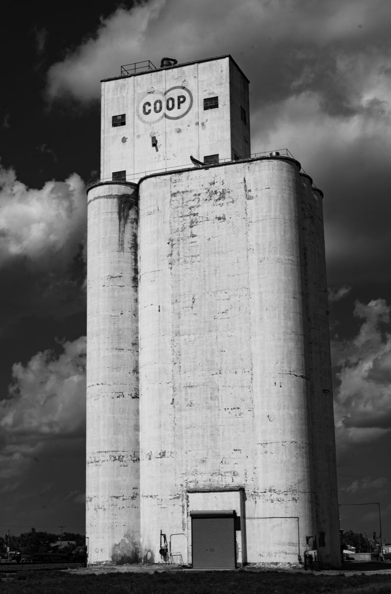 black and white image of silo with coop written on it