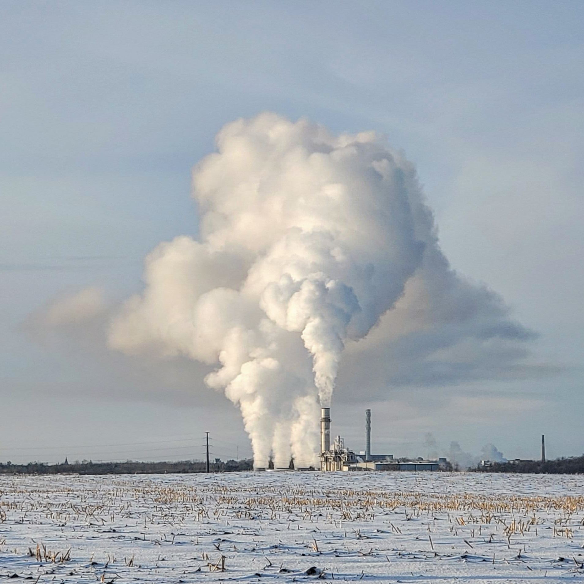 big plume of steam across snowy feild