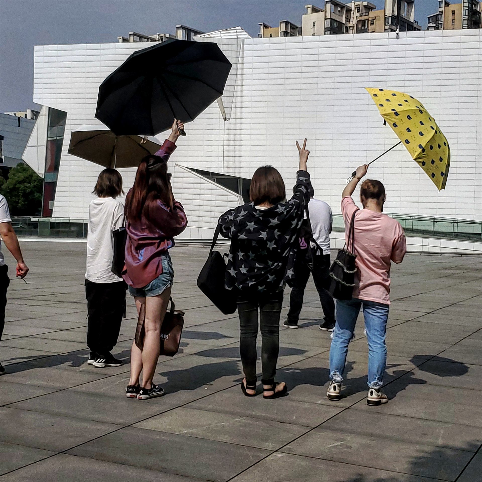 chinese students taking pictures of their shadows