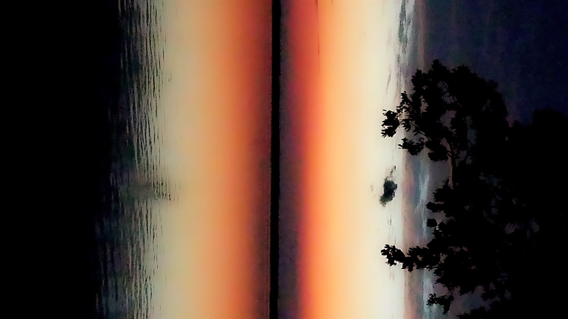 sunset over water reflects sideways view