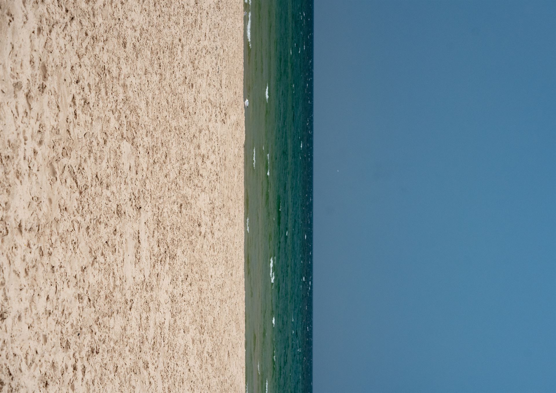 Sand water and sky in verticle orientation
