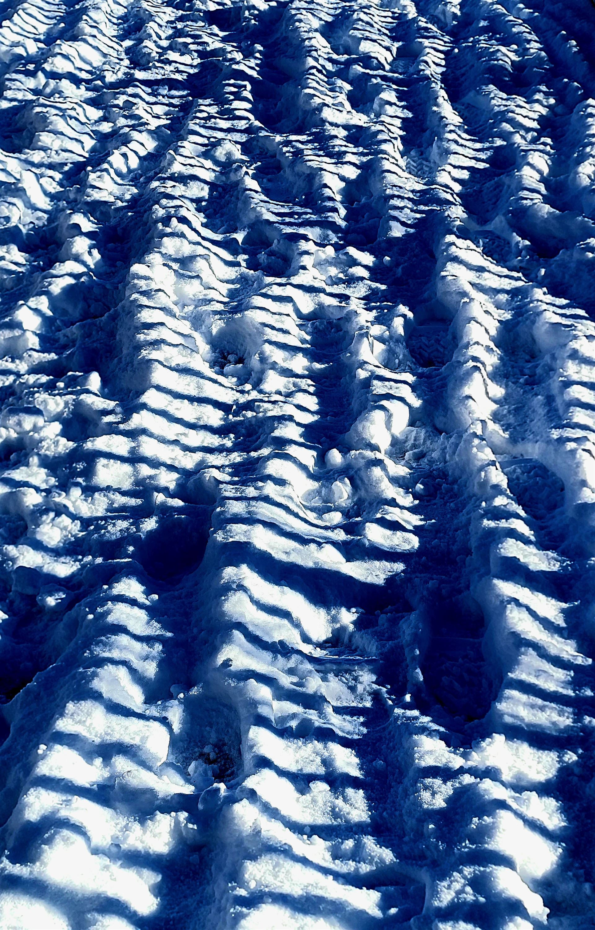 shadow lines in snow with footprints