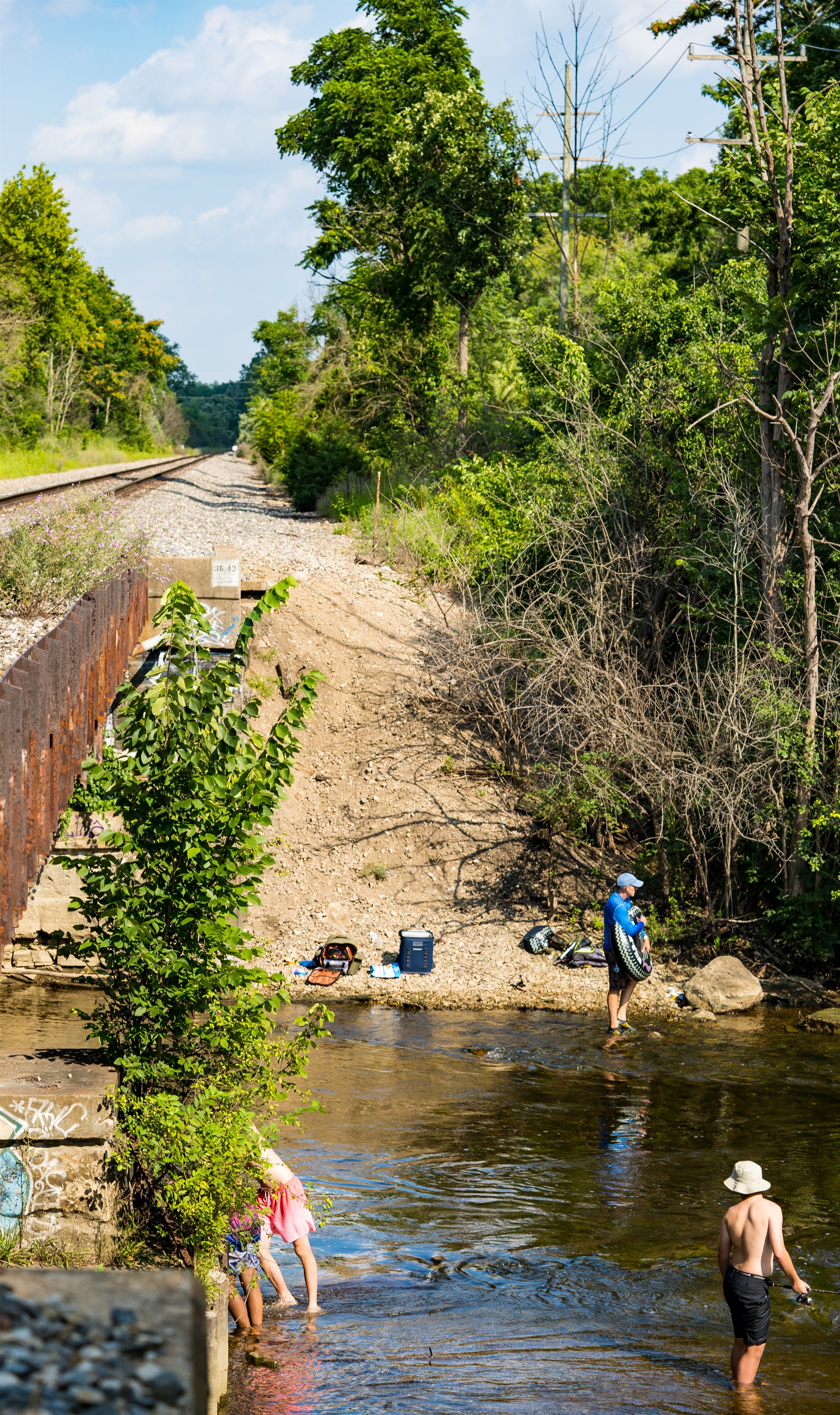 three people in river