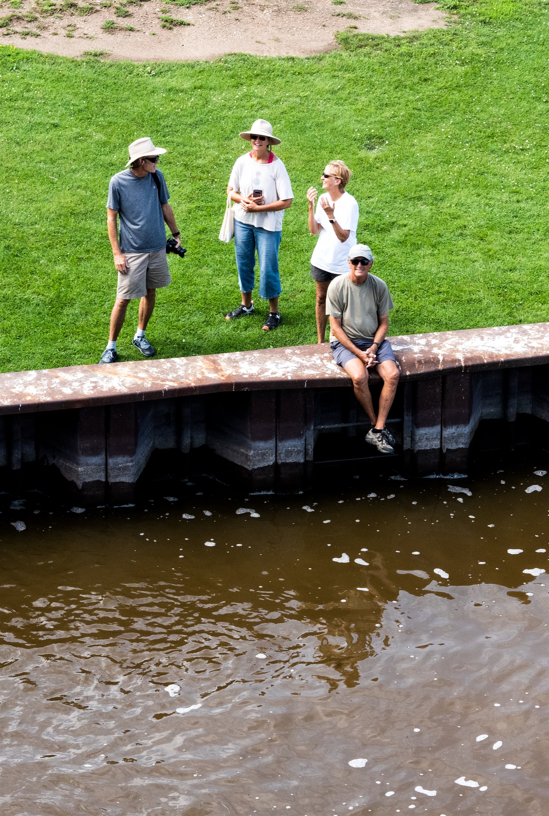 people sitting by river
