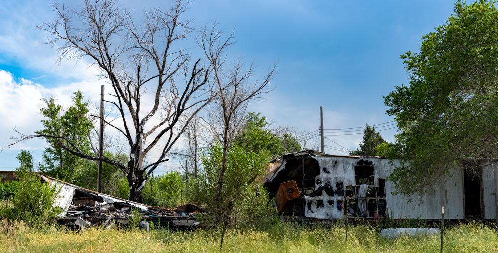 Burned out house in field